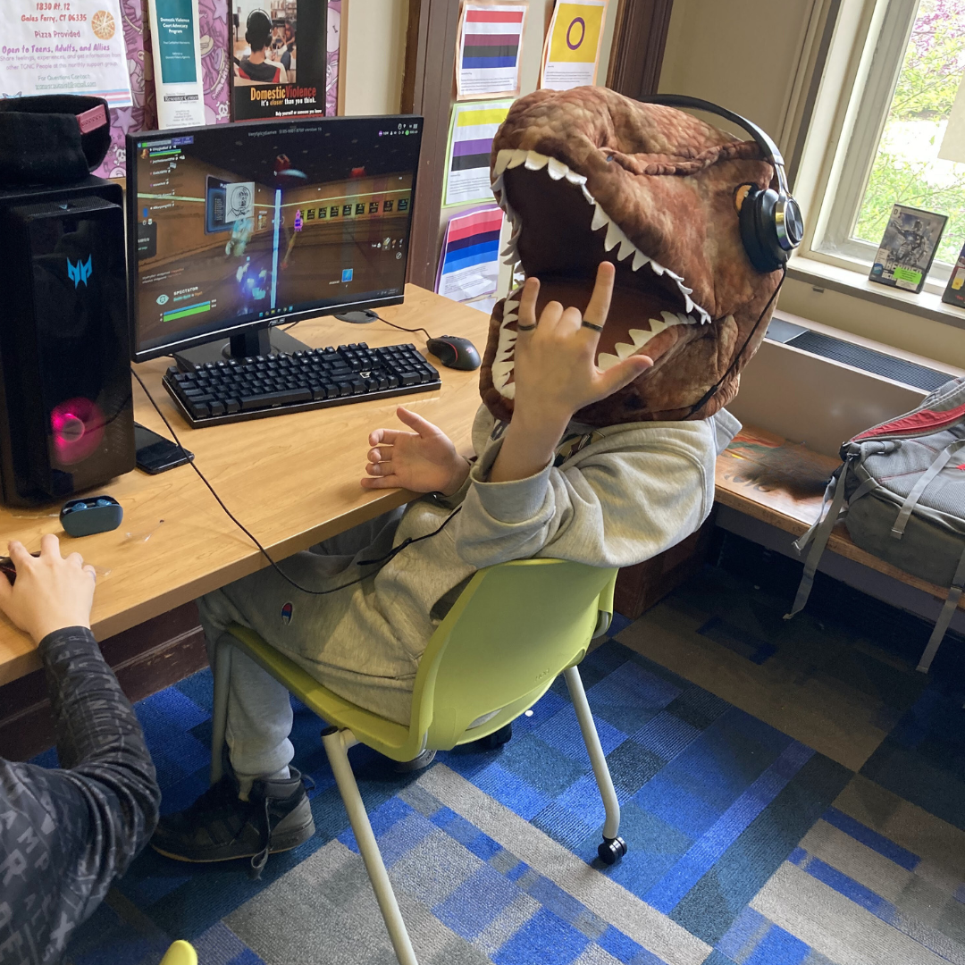 Teen with T rex mask playing Gaming PC